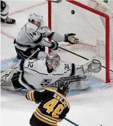  ?? STUART CAHILL / BOSTON HERALD ?? BIG NET GAIN: David Krejci fires a shot past Kings goalie Jonathan Quick during the Bruins’ 5-4 overtime victort yesterday at the Garden.