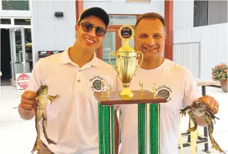  ?? SAL PIZARRO/STAFF ?? Justin Fasano, left, and his father, Bob Fasano, show off their frogs, Kermit and Green Flash, and the world champion trophy that Justin and Kermit won May 21 at the famed Calaveras County Jumping Frog Jubilee.