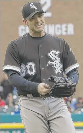  ??  ?? Derek Holland ( left) went 6„ innings and gave up two runs and five hits. David Robertson blew his first save but picked up the victory after pitching two innings. | CARLOS OSORIO/ AP