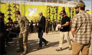  ?? AP/MAYA ALLERUZZO ?? William Roebuck (second from left), the top U.S. diplomat on the ground in northern Syria, leaves after speaking at a March 23 ceremony at the al-Omar Oil Field base to celebrate the U.S.-backed Syrian Democratic Forces defeat of Islamic State militants in Baghouz. Roebuck criticized the Trump administra­tion in an internal memo for not doing more to stand in the way of Turkey’s operation against U.S. allies in northern Syria.