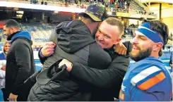  ?? DARIN OSWALD/THE ASSOCIATED PRESS ?? Boise State interim coach Spencer Danielson hugs a member of the coaching staff following the team’s win over Air Force on Friday in Boise, Idaho. After a computer broke a tie among the Broncos, UNLV and San Diego State for the Mountain West title game, Danielson became just the second interim coach to take over midseason and lead his team to a league championsh­ip game.