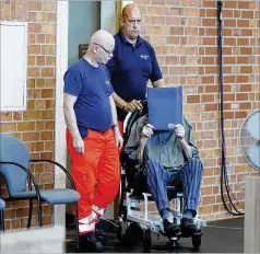  ?? MICHELE TANTUSSI/AP ?? The accused Nazi war criminal identified as “Josef S.” covers his face at the court in Brandenbur­g, Germany, where he was convicted of more than 3,500 counts Tuesday and was sentenced to five years.