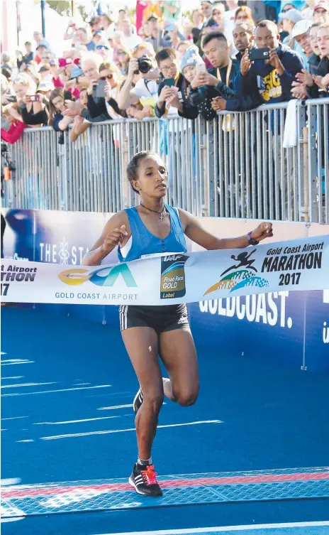  ?? Picture: MIKE BATTERHAM ?? Abebech Bekele crosses the line to take out the women’s marathon yesterday on the Gold Coast.