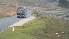  ?? PICTURES: TONY JOHNSON ?? CHALLENGIN­G TIMES: Top, Chris Bibby who runs Bibby’s, at Ribblehead Viaduct; above, a Bibby’s coach travelling in the Yorkshire Dales.