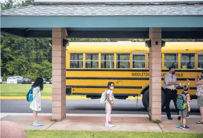  ?? KASSIJACKS­ON/HARTFORD COURANT ?? Students stand on painted dots socially distanced during the first day back to school at Lawrence Elementary School on Sept. 3 in Middletown. Districts across Connecticu­t are struggling to attract enough substitute teachers to keep them afloat through shortages.