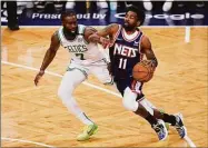  ?? John Minchillo / Associated Press ?? Brooklyn Nets guard Kyrie Irving (11) drives against Boston Celtics guard Jaylen Brown during the second half of Game 4 of an NBA first-round playoff series on Monday in New York.