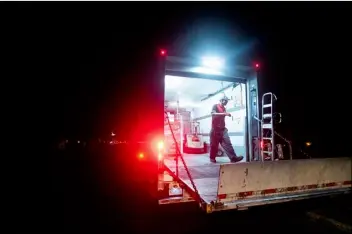  ?? AP PHOTO/NOAH BERGER ?? Ray Lopez delivers supplies to Mountain Mike’s Pizza in the Montclair district of Oakland, Calif., where power is turned off, on Thursday.