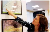  ?? AFP ?? Lebanon’s former minister for energy and water, Nada Boustani, points to a map of oil and gas blocks in the Mediterran­ean, above.