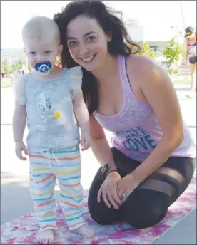  ?? BARB AGUIAR/Special to Okanagan Weekend ?? Brett Sutherland and her 18-month-old daughter, Alice, were ready for some yoga at the Okanagan’s Largest Outdoor Yoga Class at Stuart Park.