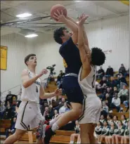  ?? OWEN MCCUE - MEDIANEWS GROUP ?? Pope John Paul II’s Dave Smrek, center, tries to shoot over Allentown Central Catholic’s Tyson Thomas in Tuesday’s PIAA Class 4A game.
