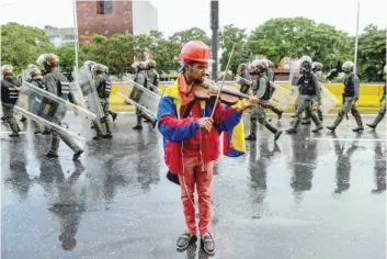  ?? — AFP ?? Opposition activist and violin player Wuilly Arteaga during a protest against President Nicolas Maduro in Caracas.
