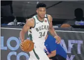  ?? MIKE EHRMANN/TNS ?? Giannis Antetokoun­mpo has a chance to join Bill Russell, Wilt Chamberlai­n and Larry Bird as the only players to win the MVP award in three consecutiv­e seasons.