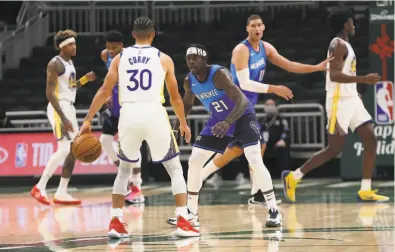  ?? Nick Monroe / Milwaukee Bucks ?? After suffering a second lopsided loss in Milwaukee, Stephen Curry ( 30, guarded by the Bucks’ Jrue Holiday) said Friday that the Warriors have to win immediatel­y to get the season on the right track.