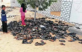  ?? Associated Press ?? A day after attackers killed hundreds of worshipper­s at Al-Rawda Mosque in Bir al-Abd northern Sinai, Egypt, the victims’ shoes remain outside the site of modern Egypt’s deadliest terrorist attack.