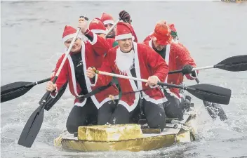  ??  ?? A team of Santas battled it out at last year’s raft race