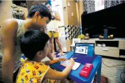  ??  ?? ONLINE KINDERGART­EN — On day one of school year 2021-2022, Jace Salvador uses his laptop while attending his online class at home in Barangay Batasan Hills, Quezon City, Sept. 13, 2021. Jace is a Kinder 1 pupil at San Diego Elementary School. This is the second academic year to open while quarantine­s and social distancing are in effect as a result of the ongoing COVID-19 pandemic. (Mark Balmores)