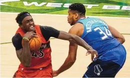  ?? MORRY GASH/ASSOCIATED PRESS ?? Toronto’s Pascal Siakam (43), a New Mexico State alum, is fouled by Milwaukee’s Giannis Antetokoun­mpo during their game Thursday night. Siakam had 27 points in the Raptors’ victory.