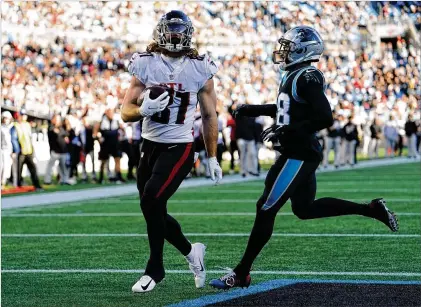  ?? JACOB KUPFERMAN/ASSOCIATED PRESS ?? Hayden Hurst scores past Panthers defensive back Myles Hartsfield during the second half Sunday as the Falcons got to 6-7. One way to look at the Falcons’ record: Arthur Smith has been coaching the heck out of what he has.
