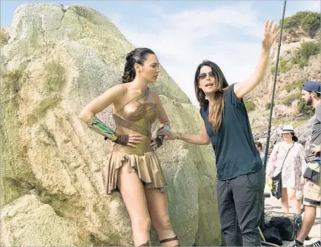  ?? Clay Enos Warner Bros. Entertainm­ent ?? GAL GADOT, left, gets direction from filmmaker Patty Jenkins on the “Wonder Woman” set, where women made up the majority.