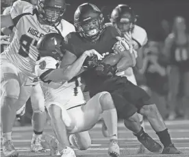  ?? PATRICK BREEN/AZCENTRAL SPORTS ?? Higley's Danny Kittner (7) tackles Saguaro's La'Ray Lucas (3) during the first half of Friday night’s game in Scottsdale.