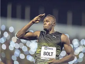  ?? GLADSTONE TAYLOR/PHOTOGRAPH­ER ?? Usain Bolt salutes the crowd at the National Stadium one last time after winning his final race in Jamaica at the JN Racers Grand Prix on Saturday night.