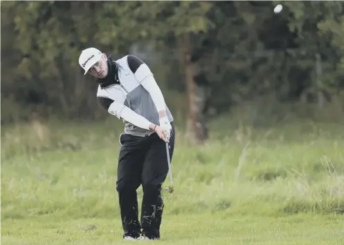  ?? PICTURE: BRIAN LAWLESS/ PA ?? 0 Ewen Ferguson plays his pitch to the 18th green during his second round at Galgorm Castle.