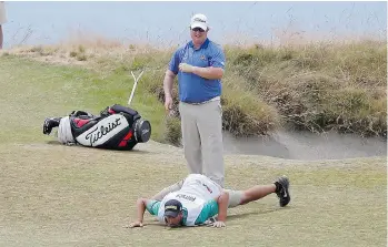  ?? LENNY IGNELZI/THE ASSOCIATED PRESS ?? Brad Fritsch watches as his caddy lines up a putt on the 15th hole during the first round of the U.S. Open golf tournament at Chambers Bay on Thursday. Fritsch was the low Canadian with an even par 70.