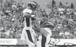  ?? MARCIO JOSE SANCHEZ/AP ?? Broncos running back Javonte Williams, left, and offensive tackle Garett Bolles celebrate a touchdown by Williams during the first half against the Chargers on Sunday in Inglewood, Calif.