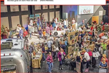  ?? [PHOTO PROVIDED] ?? BELOW: Visitors shop for items at The Gift Goes On, an event held at The Cube at Council Road Baptist Church to raise funds for Christian families adopting children both domestical­ly and internatio­nally.