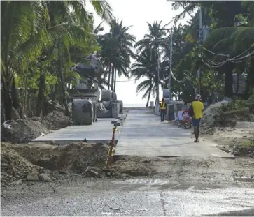  ?? ABS-CBN NEWS ?? Photo shows a local walking past a half-finished road leading to Bulabog Beach in Boracay Island.