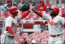  ?? JOHN MINCHILLO — THE ASSOCIATED PRESS ?? The Philadelph­ia Phillies’ Daniel Nava, left, celebrates with Mikael Franco after hitting a solo home run off Cincinnati Reds starting pitcher Rookie Davis in the first inning of Thursday’s game. Nava hit two home runs in the loss.