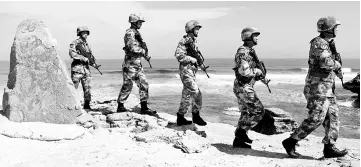  ?? — Reuters photo ?? File photo of soldiers of China’s People’s Liberation Army (PLA) Navy patrol at Woody Island, in the Paracel Archipelag­o, which is known in China as the Xisha Islands.