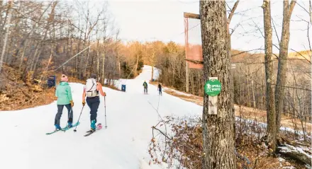  ?? JOSH LASKIN ?? Skiers skin up a slope at Cranmore Mountain Resort in North Conway, N.H., in early January. Even as more people take up alpine touring on New England’s trails, winters are getting shorter, “weather whiplash” events are eroding the snowpack and natural snow is becoming less reliable.