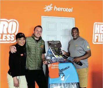  ?? ?? HERO HANDOVER: Herotel office assistant Sane Honi, left, and manager Juan du Raan, hand over surfing equipment to Amanzi Challenge managing director Zwelinzima Nkwinti at their premises on Wednesday. The Royal St Andrews Hotel Amanzi Challenge starts at West Beach on Friday November 10.