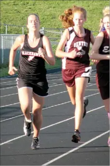  ?? Photograph courtesy of John Mcgee ?? Anna Morgan took the lead with 300 meters to go and fought off a Gentry girl by a hair in the best race of the day. Morgan’s 6:02 time in the 1,600 is a state qualifying mark, which means she has a great shot to place at the state meet.