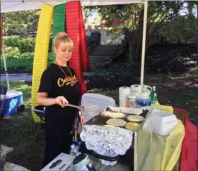  ?? BILL DEBUS — THE NEWS-HERALD ?? Edita Kuizaitis of Concord Township fries potato pancakes in the booth at the Lithuanian Cultural Garden on Sept. 16 at the 73rd annual One World Day festival in Cleveland. In Lithuania, potato pancakes are called “bulviniai blynai.”