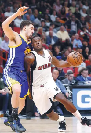  ?? WILFREDO LEE / AP ?? Dion Waiters of the Miami Heat drives around Golden State Warriors’ Klay Thompson during the second half of Monday’s game in Miami. Waiters scored 33 points to help the Heat win 105-102.