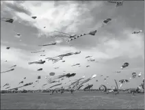  ?? ?? Above: Kites fly in the wind at a large square in Weifang, Shandong province.