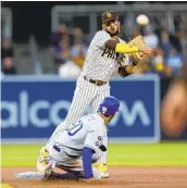  ?? K.C. ALFRED U-T ?? Shortstop Fernando Tatis Jr. turns a double play in the first inning Friday night against the Dodgers.