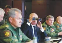  ?? AP PHOTO ?? Russian President Vladimir Putin, Defence Minister Sergei Shoigu, left, and Chief of the General Staff of the Russian Armed Forces Valery Gerasimov, second right, watch a military exercise at a training ground at the Luzhsky Range, near St. Petersburg,...