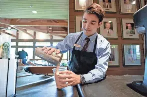  ?? ADAM CAIRNS/COLUMBUS DISPATCH ?? Michael Moore of Columbus pours a Buckeye-flavored milkshake in the player’s dining room during a practice round for the 2022 Memorial Tournament.