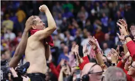  ?? Photograph: Michael Reaves/Getty Images ?? Arkansas coach Eric Musselman ripped his polo shirt off and shouted with joy after the Razorbacks’ upset of No 1 seed Kansas on Saturday night.