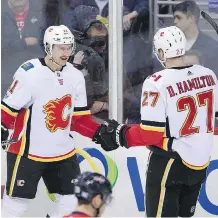  ?? NICK WASS/THE ASSOCIATED PRESS ?? Flames forward Mikael Backlund, left, had reason to celebrate with teammate Dougie Hamilton Saturday after scoring his 100th regular season NHL goal.