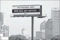  ??  ?? Burden: A Milwaukee sign shows each citizen’s share of national debt.