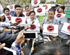  ?? HONG MENEA ?? Union members speak to the press at a protest against the Trade Union Law in Phnom Penh last year.