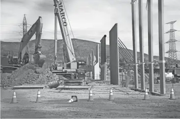  ?? DAVID WALLACE/REPUBLIC ?? Building of border-wall prototypes takes place on Oct. 17 near the Otay Mesa Port of Entry in San Diego.