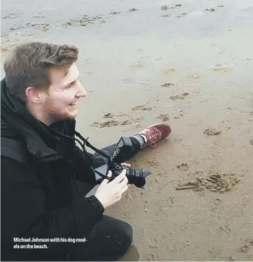  ??  ?? Michael Johnson with his dog models on the beach.