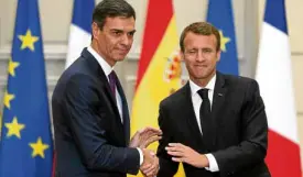  ?? —AP ?? SANCTIONSC­OMING French President Emmanuel Macron (right) shakes hands with Spanish Prime Minister Pedro Sanchez.