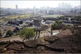  ?? THE ASSOCIATED PRESS ?? Los Angeles Fire Department Fire Arson Counter-Terrorism investigat­ors check a burned out homeless camp after a brush fire erupted in the hills in Elysian Park in Los Angeles Thursday, Dec. 14, 2017. The National Weather Service said extreme fire...