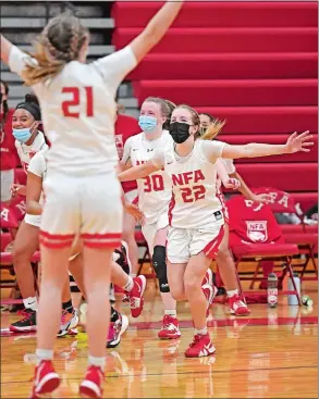  ?? Theday.com SEAN D. ELLIOT/THE DAY ?? Norwich Free Academy’s Sarah Ericson (22) runs toward teammate Jayna Neault (21) in celebratio­n as the bench rushes on to the court after beating Waterford 57-33 in the Eastern Connecticu­t Conference South Division girls’ basketball tournament final on Thursday in Norwich. Please go to to view a photo gallery from the game.